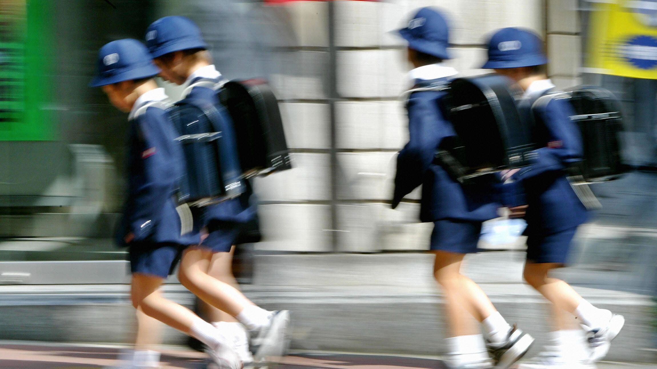 Tokyo schoolchildren make their way home from class in this 2004 file photo. Japan is experiencing its highest-ever number of reports of child abuse.