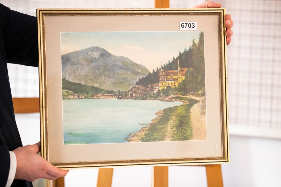 One of the watercolors, entitled Ortschaft an Vorgebirgssee, depicts a village near a mountain lake   