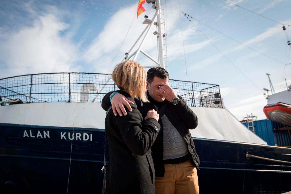 Abdullah Kurdi and his sister Tima embrace in front of a rescue ship named after his son Alan Kurdi at its inauguration 2019 in Palma de Mallorca, Spain.