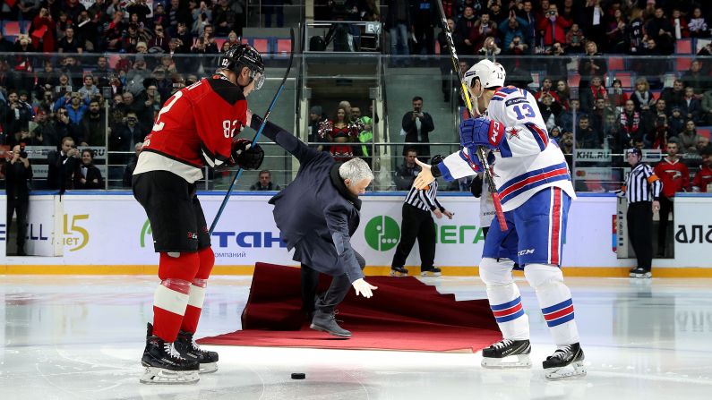 Former soccer manager Jose Mourinho slips on the ice after taking part in a ceremonial puck drop in Balashikha, Russia, on Monday, February 4.