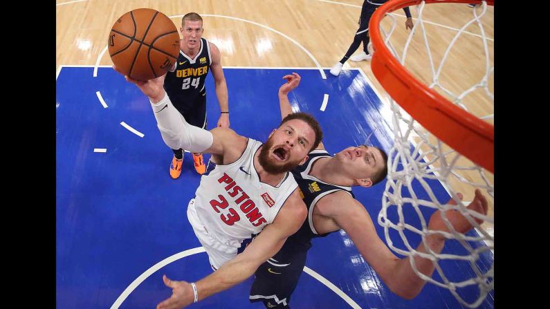 Detroit's Blake Griffin gets a shot off as he's defended by Denver's Nikola Jokic on Monday, February 4.