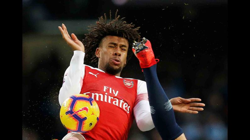 Arsenal's Alex Iwobi flinches as the boot of Manchester City's Nicolas Otamendi flies near his face during a Premier League match in Manchester, England, on Sunday, February 3.