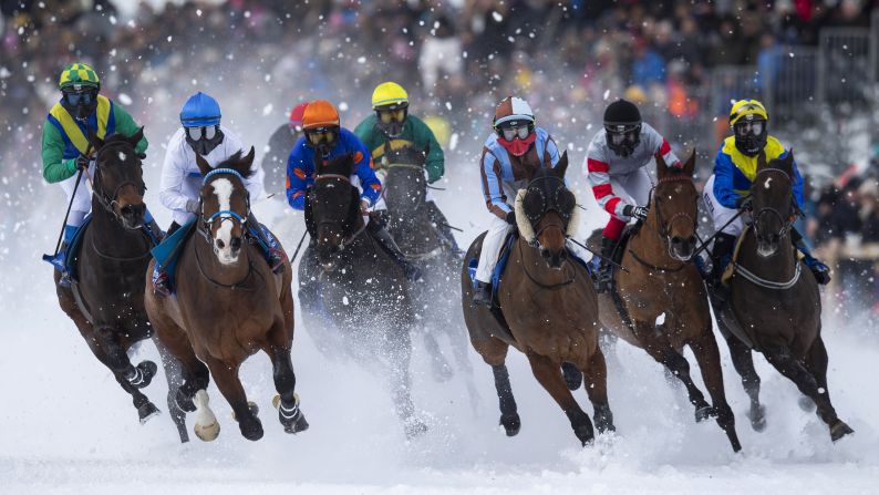 Horses race in snowy conditions in St. Moritz, Switzerland, on Sunday, February 10.