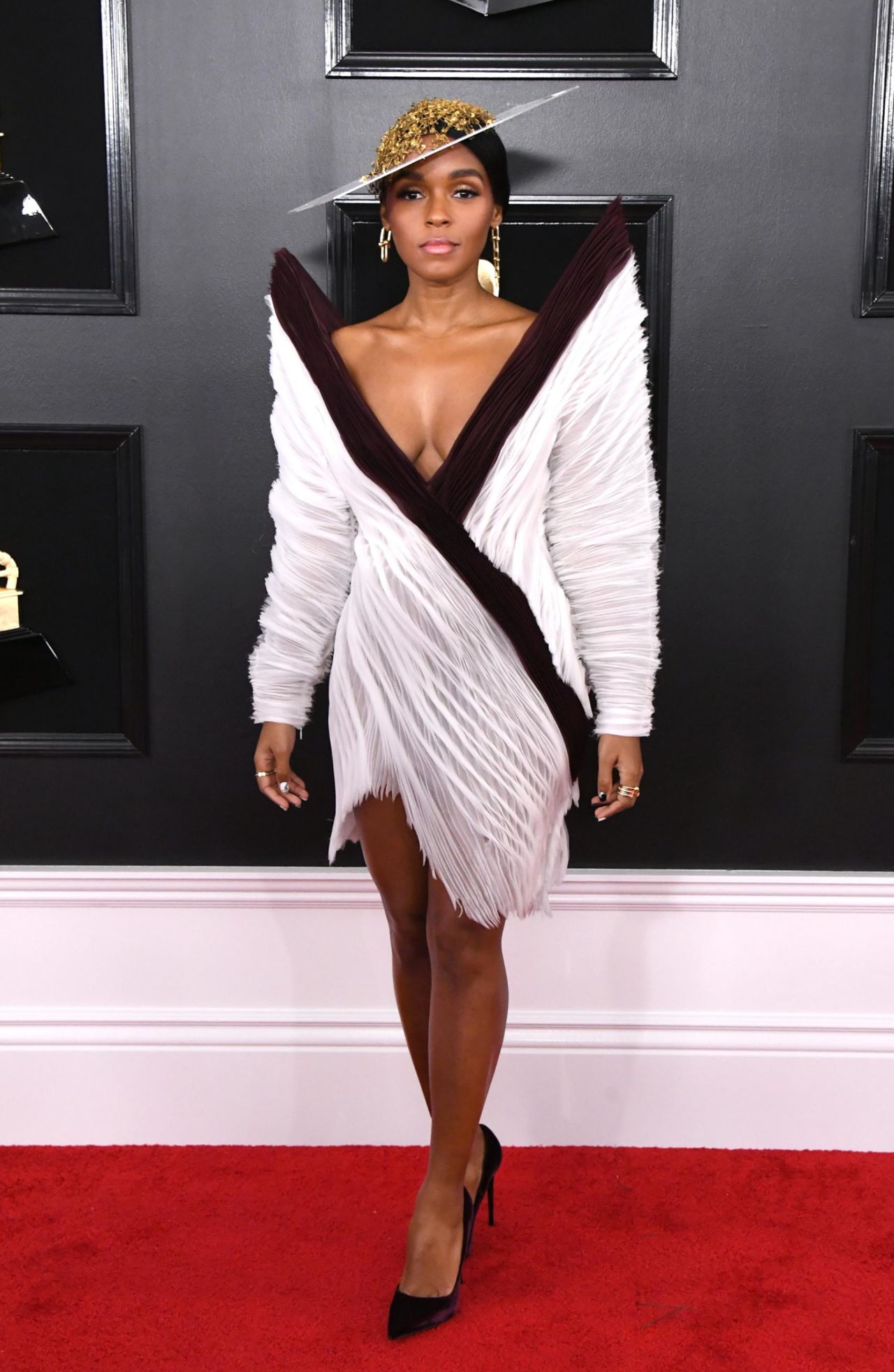 Janelle Monáe poses in a Jean Paul Gaultier's couture dress with a gold and white wide-brim hat. <br />