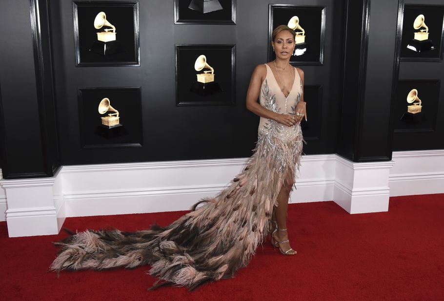 Jada Pinkett Smith walked the red carpet in a pink dress with a long feathery train.