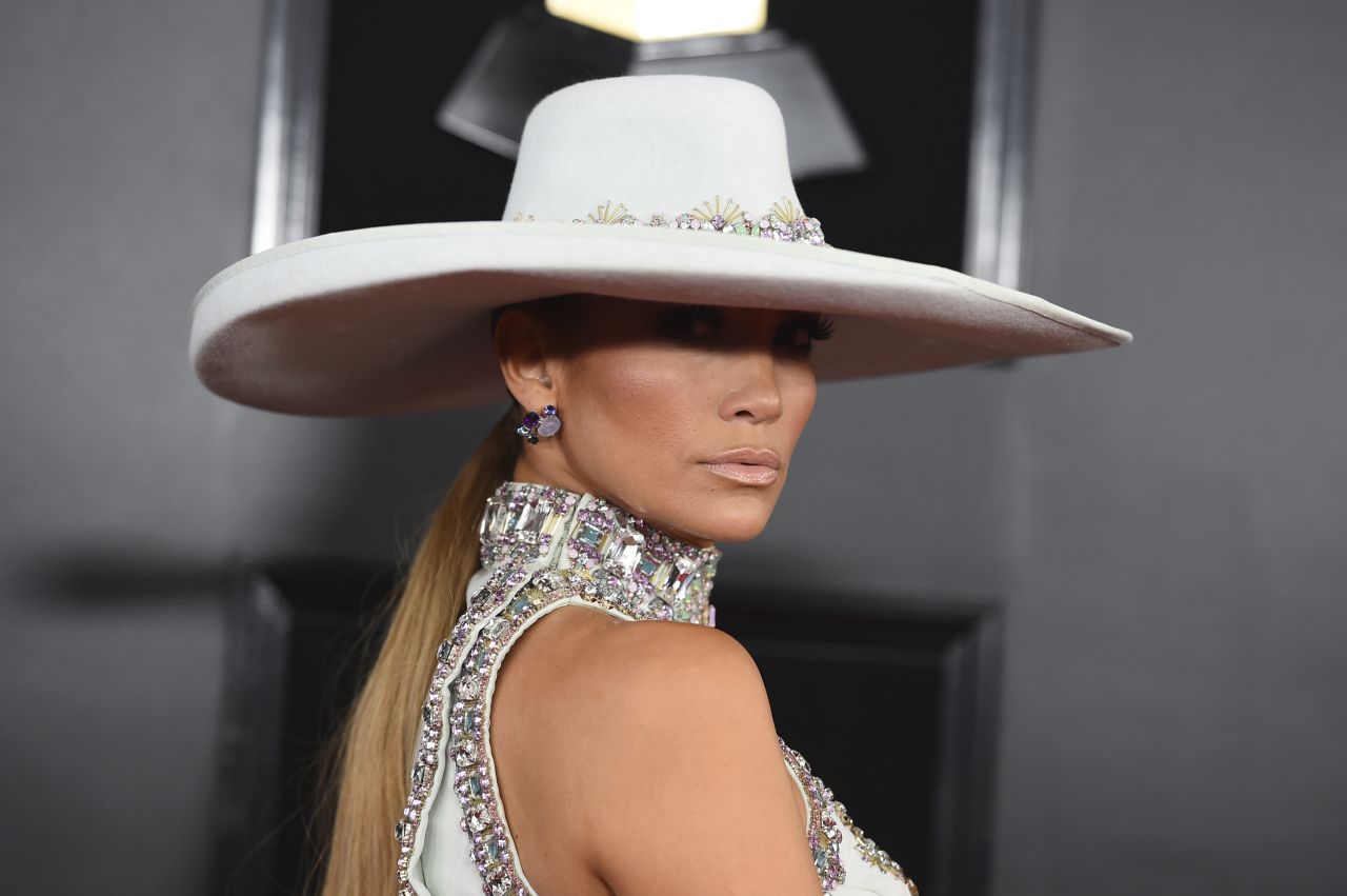 Jennifer Lopez arrives at the Grammys in a high-neck white gown covered in crystals, by Ralph & Russo. 