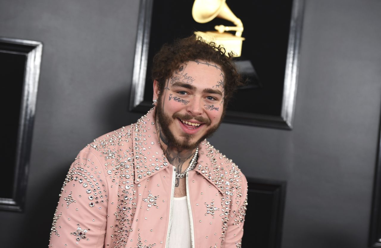 Post Malone arrives at the 61st annual Grammy Awards in a studded pink suit. 