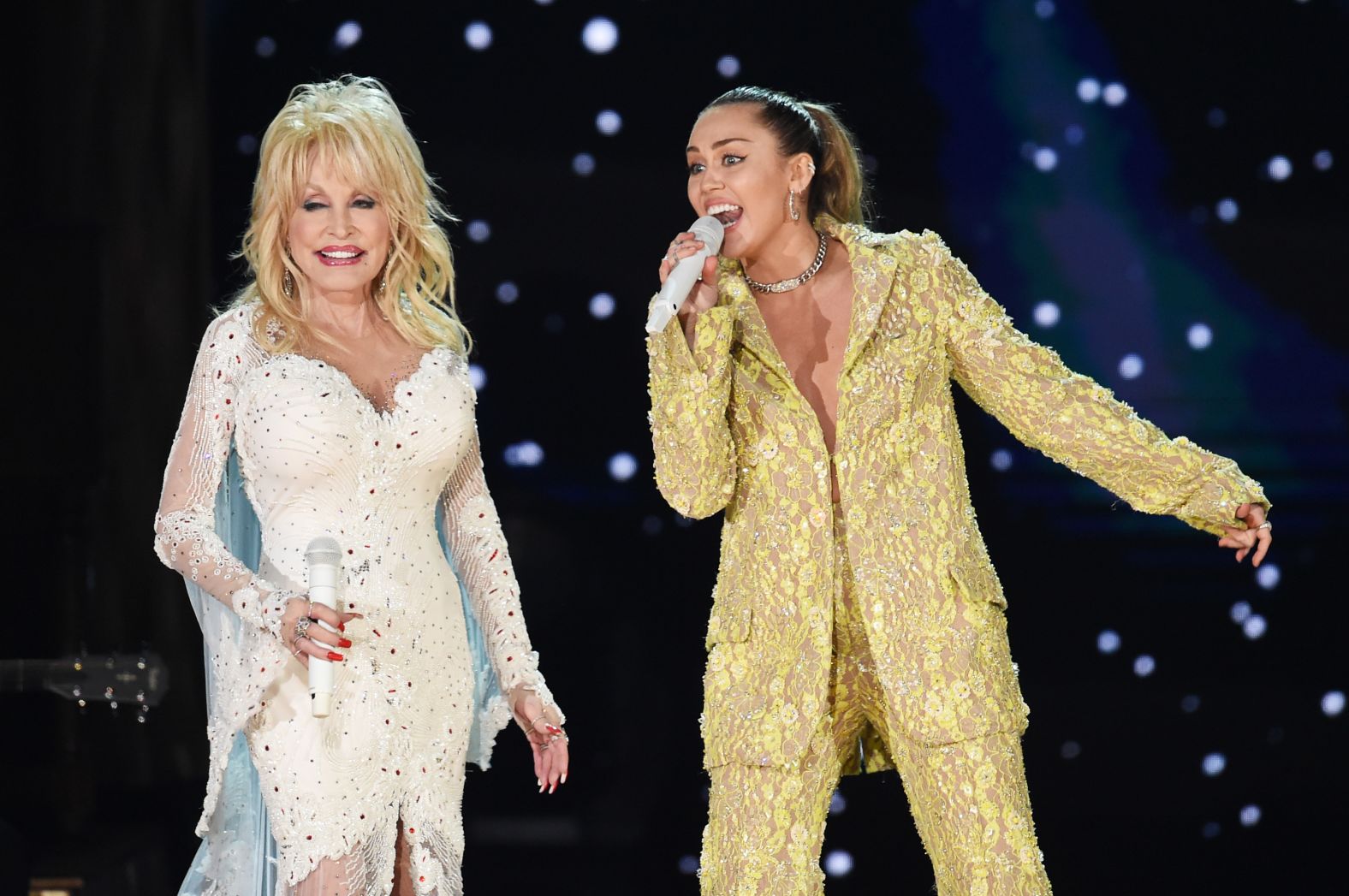 Miley Cyrus sings with Parton during the tribute, which included the songs "Here You Come Again," "Jolene" and "9 to 5."