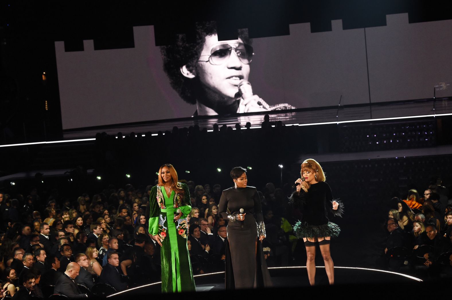 An image of the late Aretha Franklin is projected on a screen while Yolanda Adams, Fantasia and Andra Day perform a tribute.