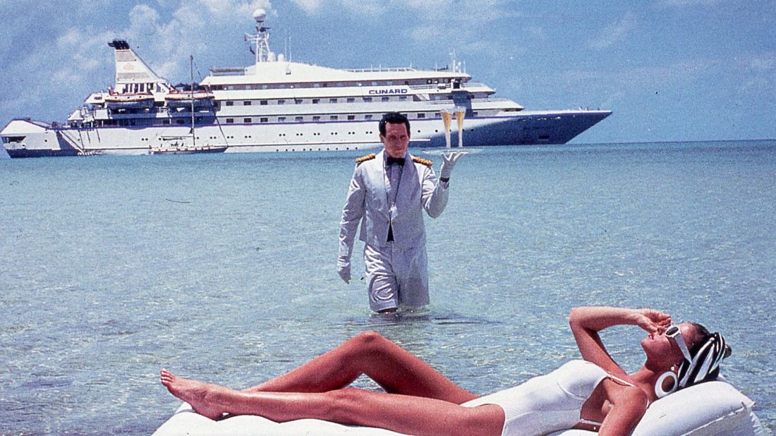 <strong>Lap of luxury</strong>: Lounging in the ocean, awaiting a guy bringing you two glasses of champagne = ultimate vacation goals. This is apparently how cruising worked in the 1980s.