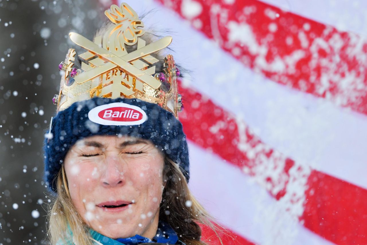 Mikaela Shiffrin closes her eyes as her runners-up celebrate by throwing snowballs at her in Kronplatz.