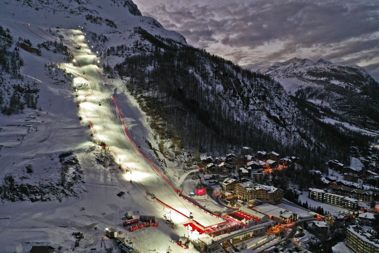 The giant slalom slope of Val d'Isère shines amid dark skies; the slalom was canceled because of bad weather.
