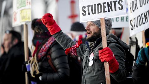 Denver high school social studies teacher Nick Childers chants as teachers picket outside South High School on February 11, 2019, in Denver. Denver teachers were striking for the first time in 25 years after the school district and the union representing the educators failed to reach an agreement following 14 months of contract negations over teacher pay.