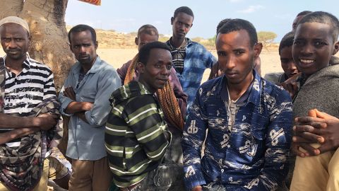 A group of men wait for smugglers to arrive to take them across the Bab al-Mandeb Strait to Yemen.