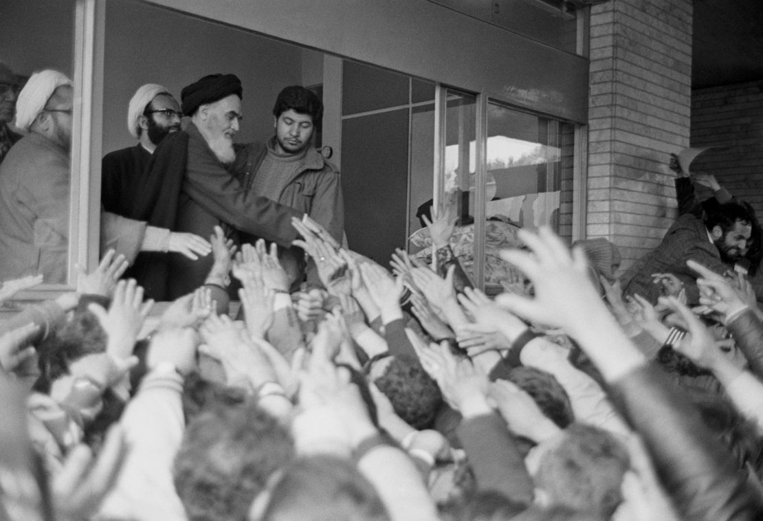 Ayatollah Rouhollah Khomeini greets the crowd at Tehran University after his return to Iran during the Iranian Revolution.
