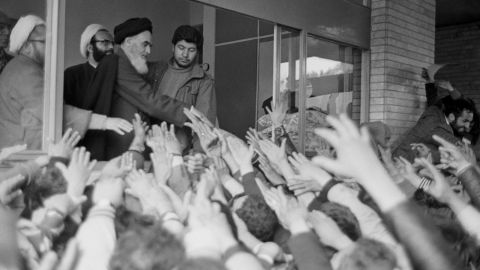 Ayatollah Rouhollah Khomeini greets the crowd at Tehran University after his return to Iran during the Iranian Revolution.