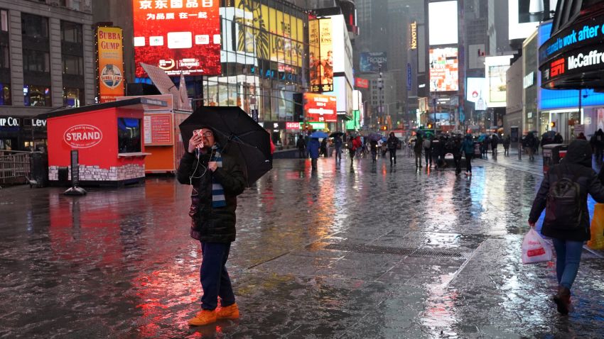 People are reflected in the snow covered street in Times Square March 7, 2018  as a  nor'easter hits the east coast causing havoc for commuters and causing cancellations and closings.The second winter storm in less than a week struck the northeastern United States Wednesday, with more than 2,000 flights canceled as the region braced for heavy snow.Around 520 flights arriving and departing from John F Kennedy International Airport -- nearly 42 percent of the total scheduled -- were canceled by 12:00 pm (1700 GMT), along with 650 flights from New Jersey's Newark airport and nearly 600 from La Guardia, which operates primarily domestic flights, according to the FlightAware flight tracking site. / AFP PHOTO / TIMOTHY A. CLARY        (Photo credit should read TIMOTHY A. CLARY/AFP/Getty Images)