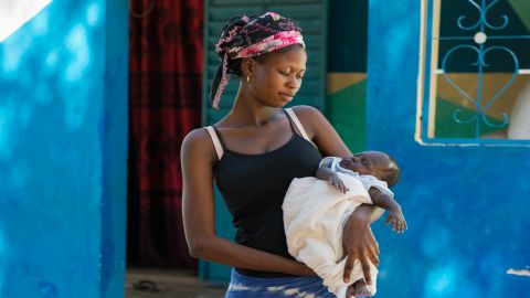 Aby Faye, 17, holds her two month old baby, Sokhna. Faye says she was aware of the importance of iodine during pregnancy thanks to Marie's campaigning in their village.