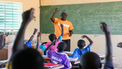 Pape Coumb Ndoffene Faye, headteacher of Ndiemou's primary school, calls on students during a French lesson.