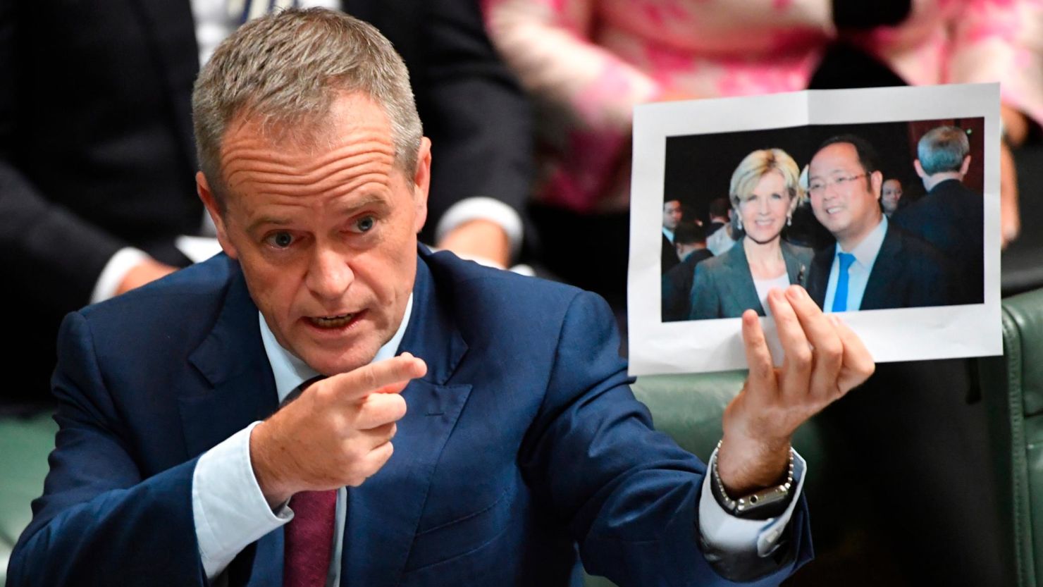 Leader of the opposition Labor Party Bill Shorten holds a photograph of Minister for Foreign Affairs Julie Bishop and Chinese businessman Huang Xiangmo in 2017.