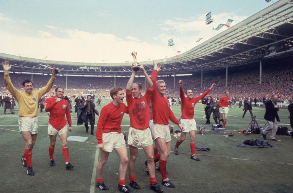 Bobby Charlton raises the Jules Rimet trophy in the air  following England's 4-2 victory after extra time over West Germany.