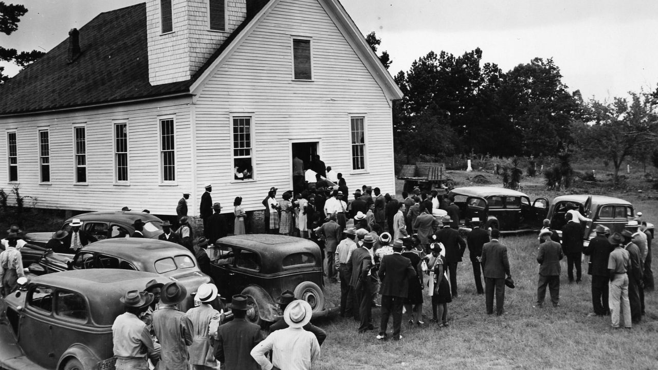 Mourners gather at a church near Monroe, Georgia, in 1946 for the funerals of four black sharecroppers. 