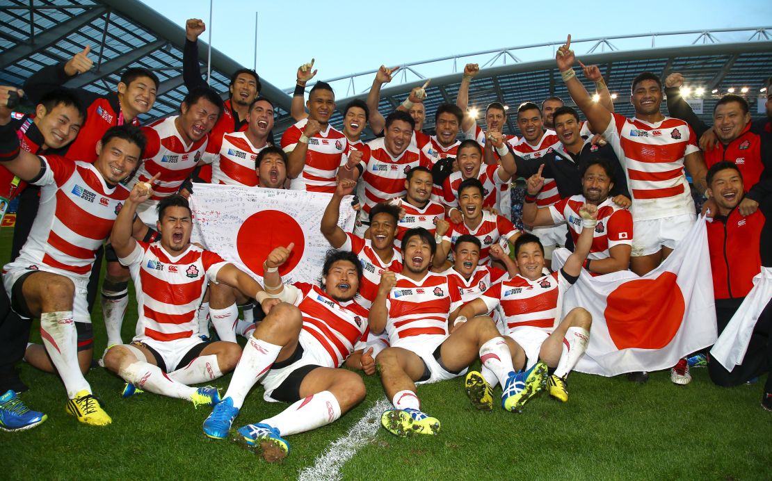Japanese players celebrate defeating South Africa at the 2015 Rugby World Cup