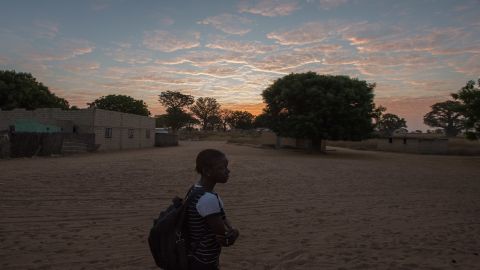 Marie's daughter Fatou, backpack in tow, sets off early one morning for school.