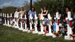 PARKLAND, FL - FEBRUARY 18: People visit a makeshift memorial in front of the Marjory Stoneman Douglas High School where 17 people were killed on February 14, on February 18, 2018 in Parkland, Florida. Police arrested 19-year-old former student Nikolas Cruz for killing 17 people at the high school.  (Photo by Mark Wilson/Getty Images)