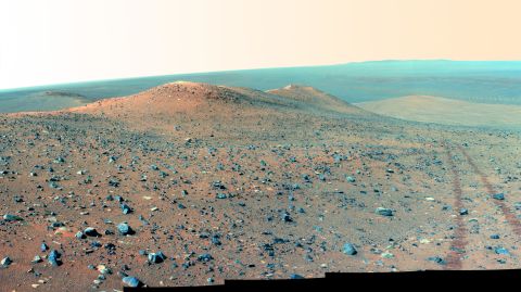 Oppy's panoramic camera gathered this mosaic in 2014 of Wdowiak Ridge, as well as the rover's tracks to the right. This is about 70 degrees from north/northwest to east/northeast, showing the 500-feet ridge that rises 40 feet tall. 
