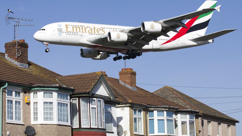 An Emirates Airbus A380 aircraft is seen above roof top as it comes into lane at Heathrow Airport in west London on February 18, 2015. Heathrow's expansion plan to build a third runway is backed by trade unions, airlines and businesses, but opposed by many residents, British media report. London's Heathrow is Europe's busiest in terms of passenger numbers, and the world's busiest for international passenger traffic. AFP PHOTO / JUSTIN TALLIS (Photo by Justin TALLIS / AFP)        (Photo credit should read JUSTIN TALLIS/AFP/Getty Images)