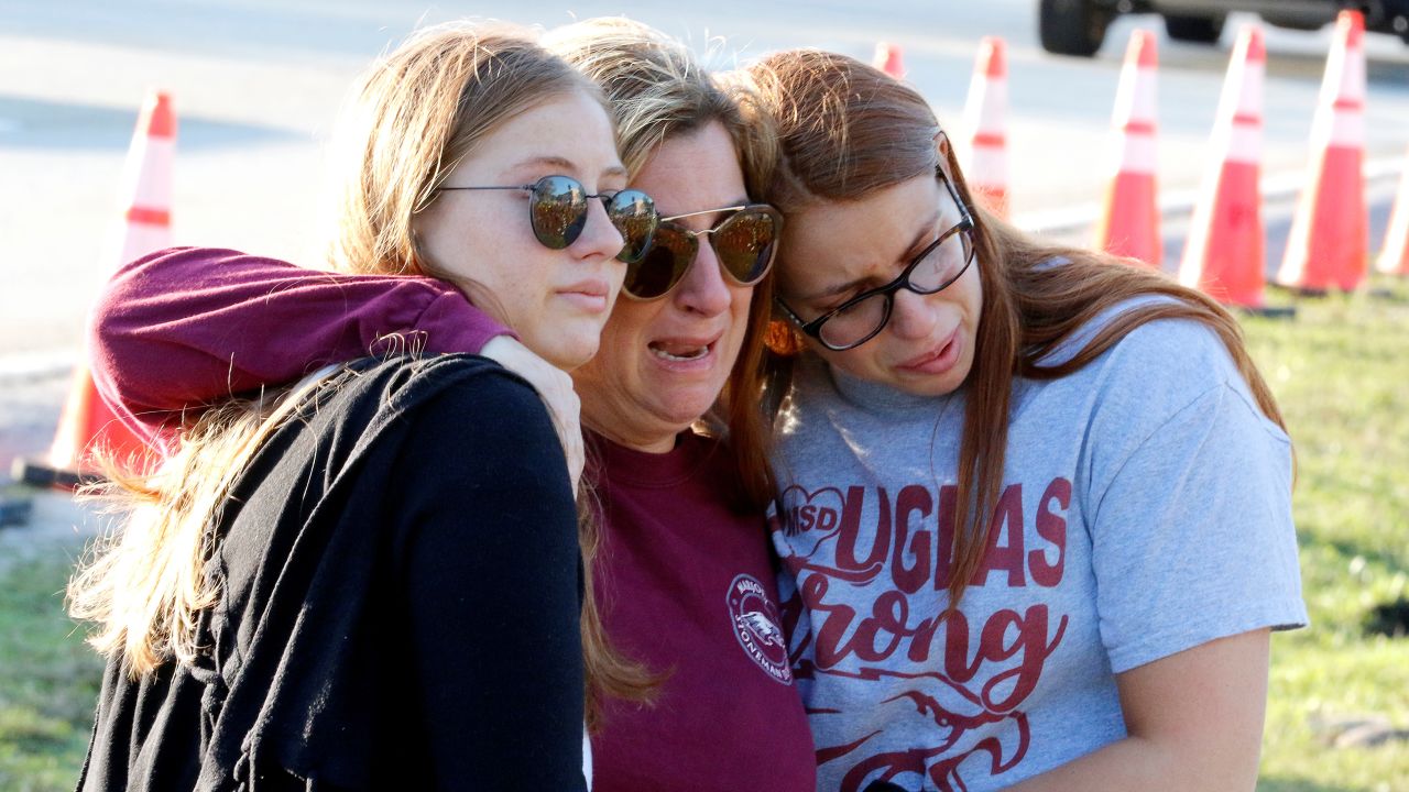 Cheryl Rothenberg and daughters Emma and Sofia view a memorial on <a href="http://www.cnn.com/2019/02/14/us/gallery/parkland-anniversary/index.html" target="_blank">the one-year anniversary</a> of the massacre at Marjory Stoneman Douglas High School in Parkland, Florida. Gunman Nikolas Cruz, a former student, slaughtered 17 people at the school on February 14, 2018.