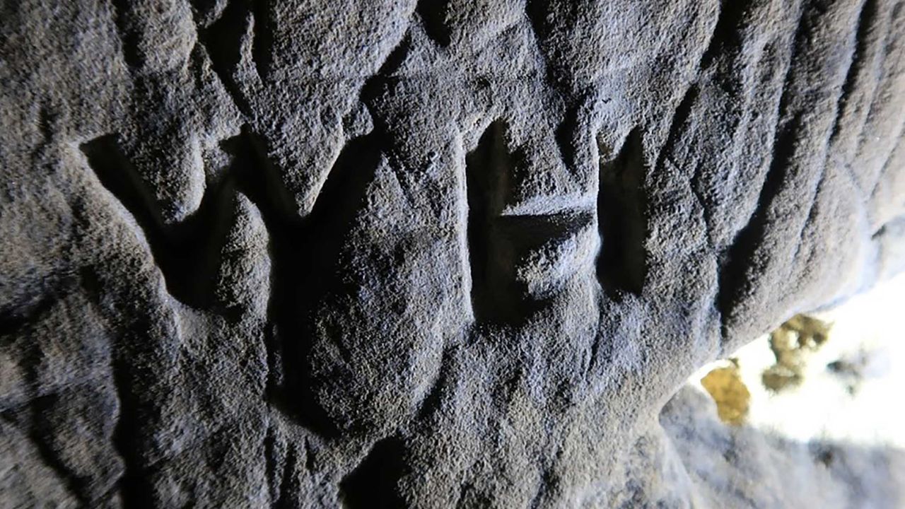 Witch marks have been found covering a cave in the East Midlands CREDIT: Historic England