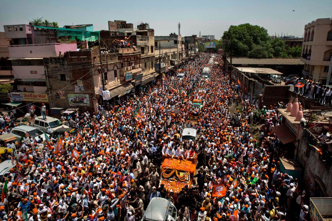 BJP leader Narendra Modi waves to supporters on his way to filing his nomination papers on April 24, 2014 in Varanasi, India. 