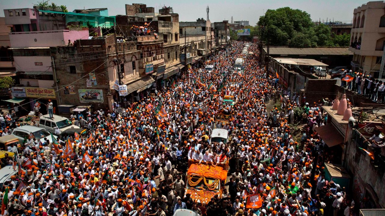 BJP leader Narendra Modi waves to supporters on his way to filing his nomination papers on April 24, 2014 in Varanasi, India.