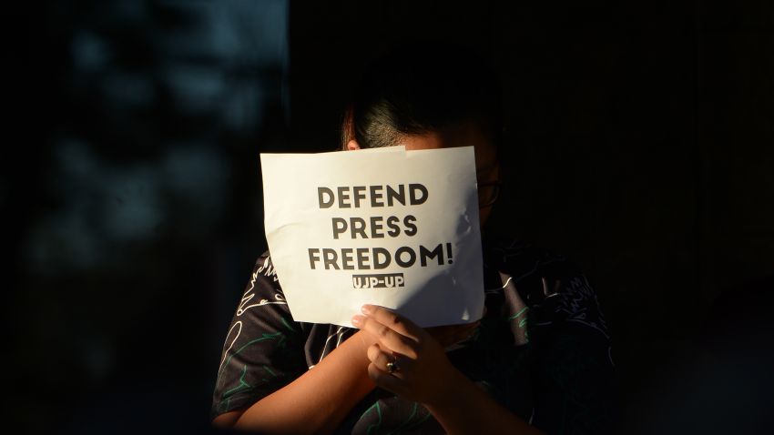 TOPSHOT - A student holds a placard during a protest at the state university grounds in Manila on February 14, 2019, in support of CEO of Rappler, Maria Ressa, who was arrested a day earlier for cyber libel case. - Ressa was freed on bail on February 14 following an arrest that sparked international censure and allegations she is being targeted over her news site's criticism of President Rodrigo Duterte. (Photo by TED ALJIBE / AFP)        (Photo credit should read TED ALJIBE/AFP/Getty Images)