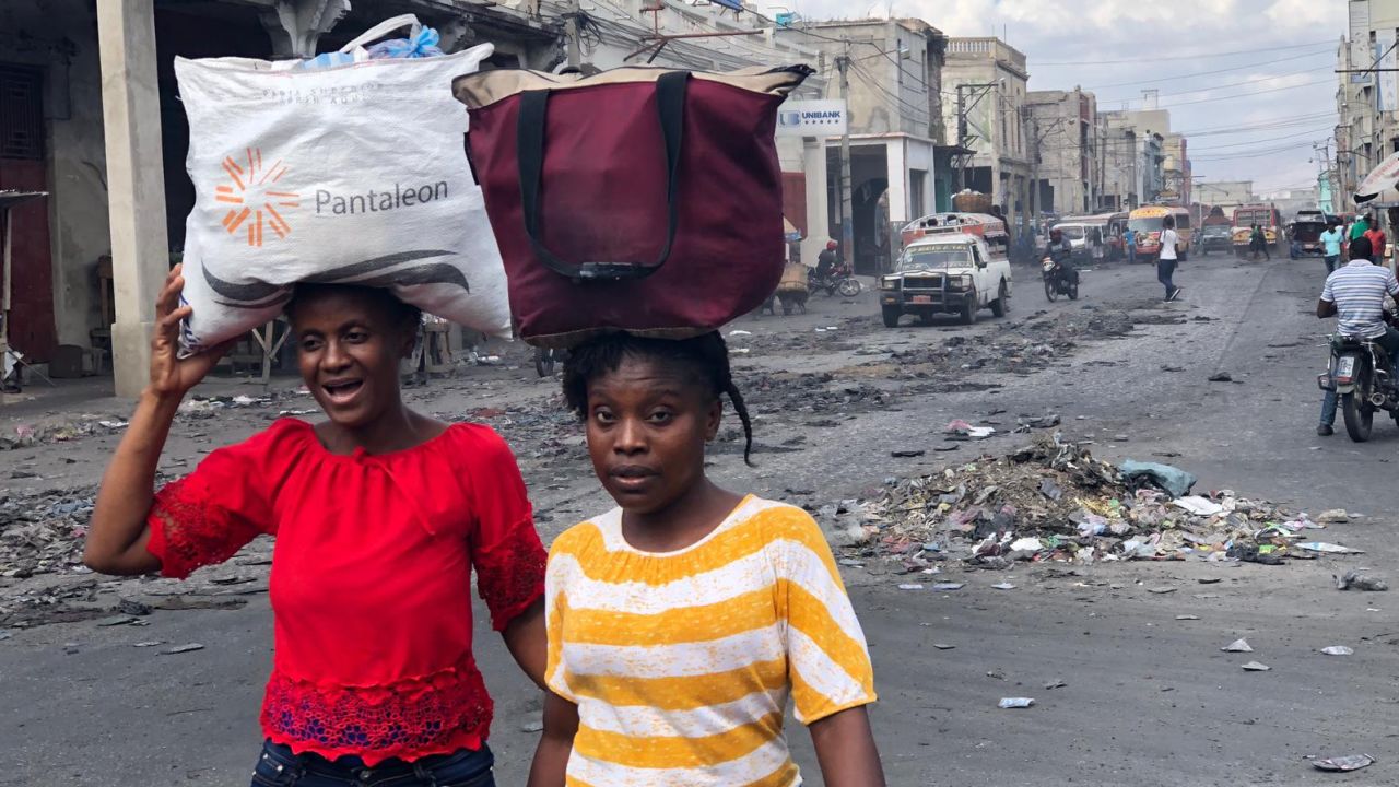 Two women walk Saturday in downtown Port-au-Prince , which is usually busy with shoppers.