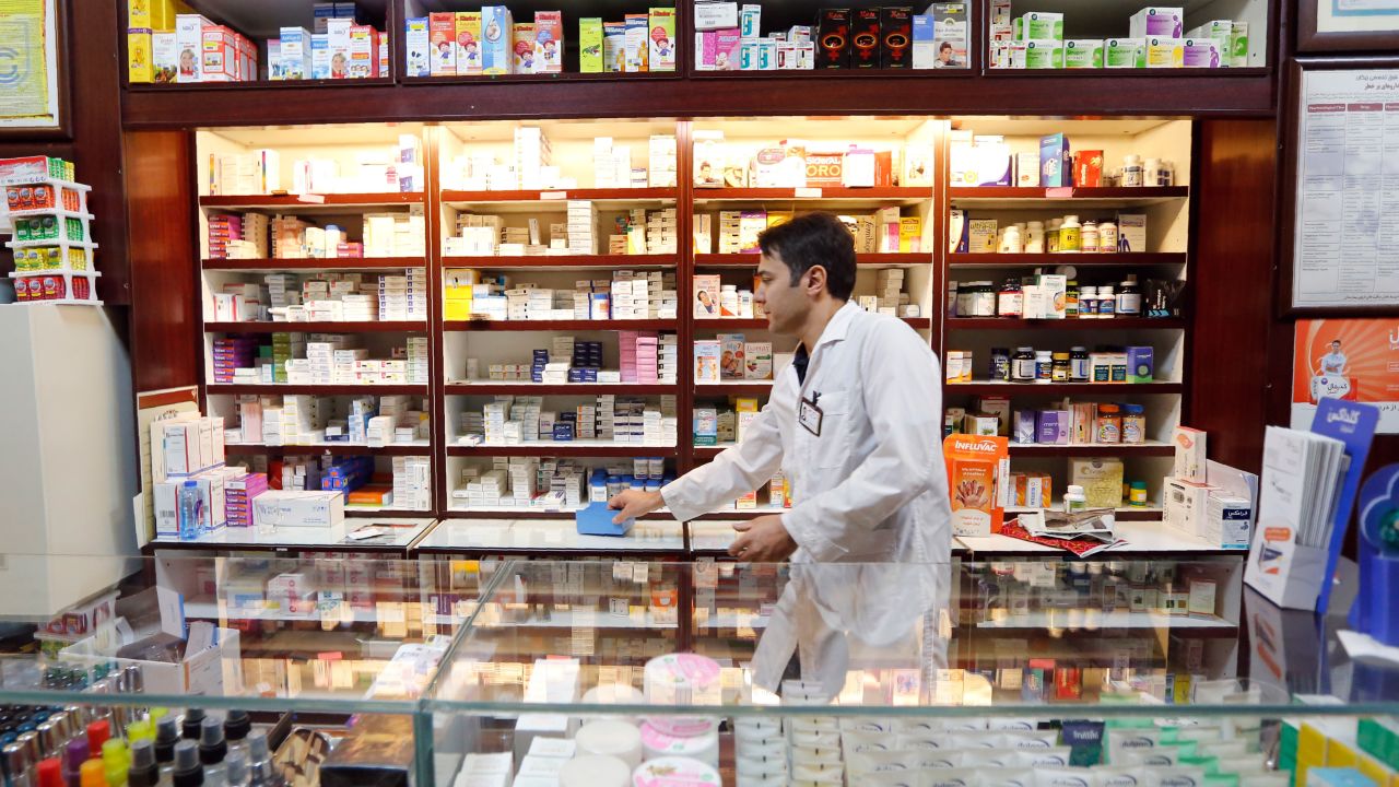 An Iranian man works at a drugstore at the Nikan hospital in Tehran.