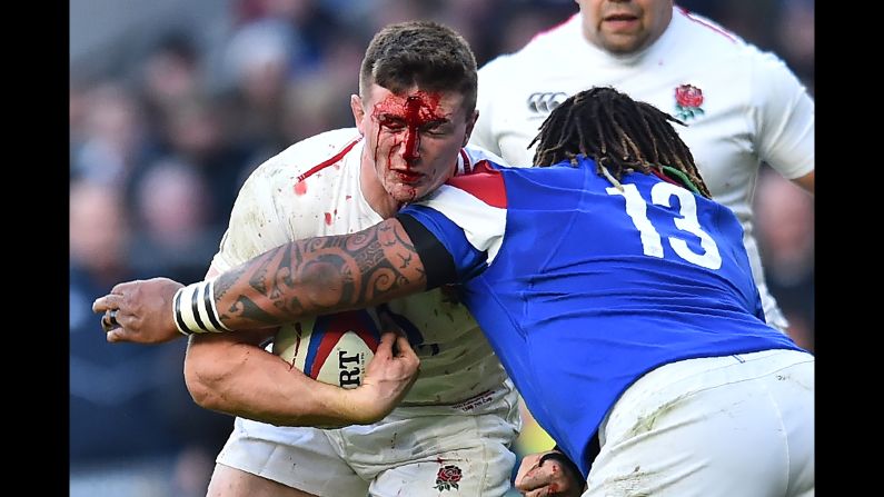 England's flanker Tom Curry is tackled by France's center Mathieu Bastareaud during the Six Nations international rugby union match on Sunday, February 10.