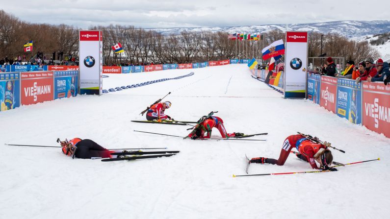 Competitors collapse in the finish area after competing in the women's 7.5 km sprint of the IBU World Cup Biathlon February 14 in Midway, Utah.