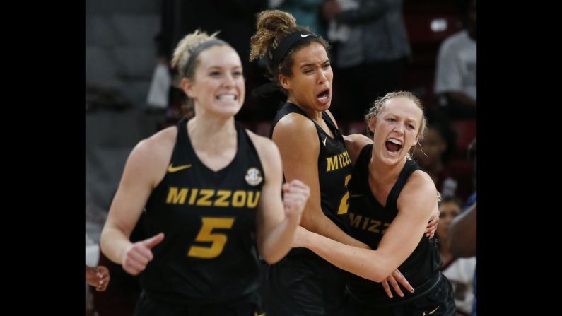 Missouri forward Cierra Porter, center, hugs guard Sophie Cunningham, while guard Lauren Aldridge celebrates after Missouri defeated Mississippi State on Thursday, February 14.