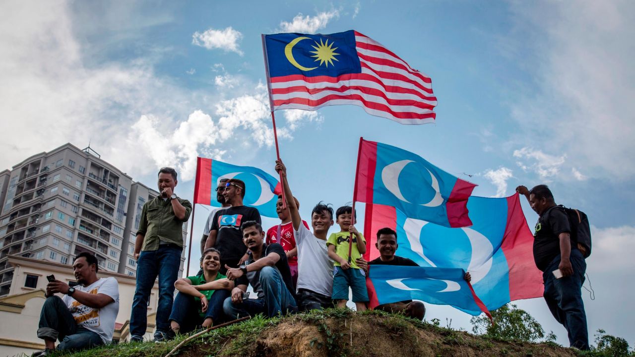 Supporters of Mahathir Mohamad, chairman of Pakatan Harapan (The Alliance of Hope), wait for Mohamed to be sworn in as Malaysian prime minister, outside the National Palace 'Istana Negara' on May 10, 2018 in Kuala Lumpur, Malaysia.