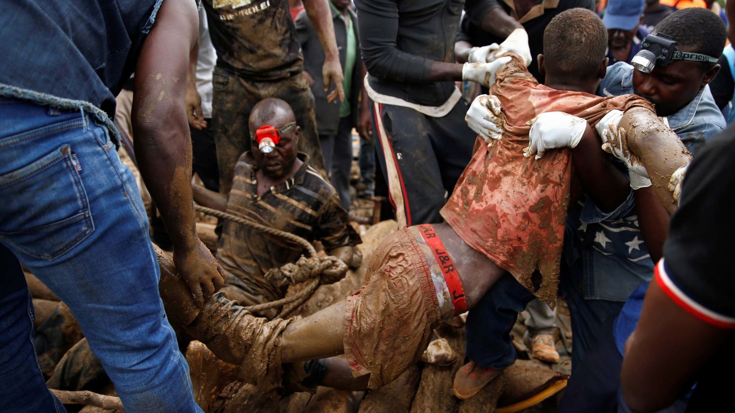 A rescued miner is carried from a pit at the mining site on Saturday.