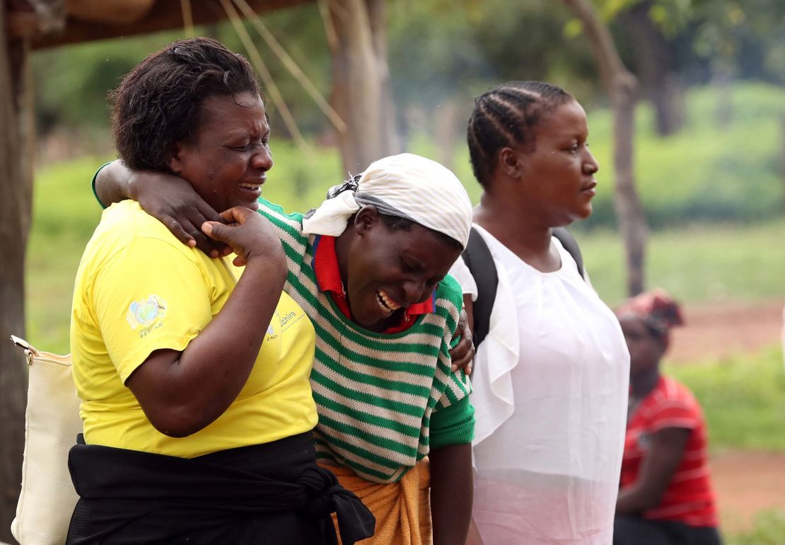 Women console a mourner as relatives arrive to await news on the return of the body of one of the miners.