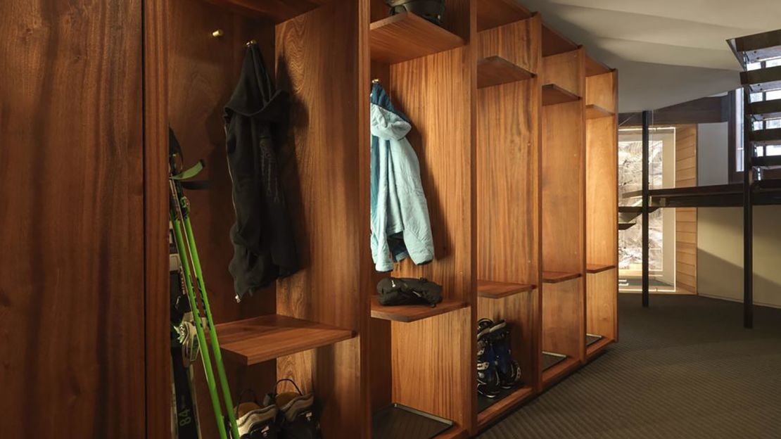 The ski lockers are made out of sapele wood and brass.