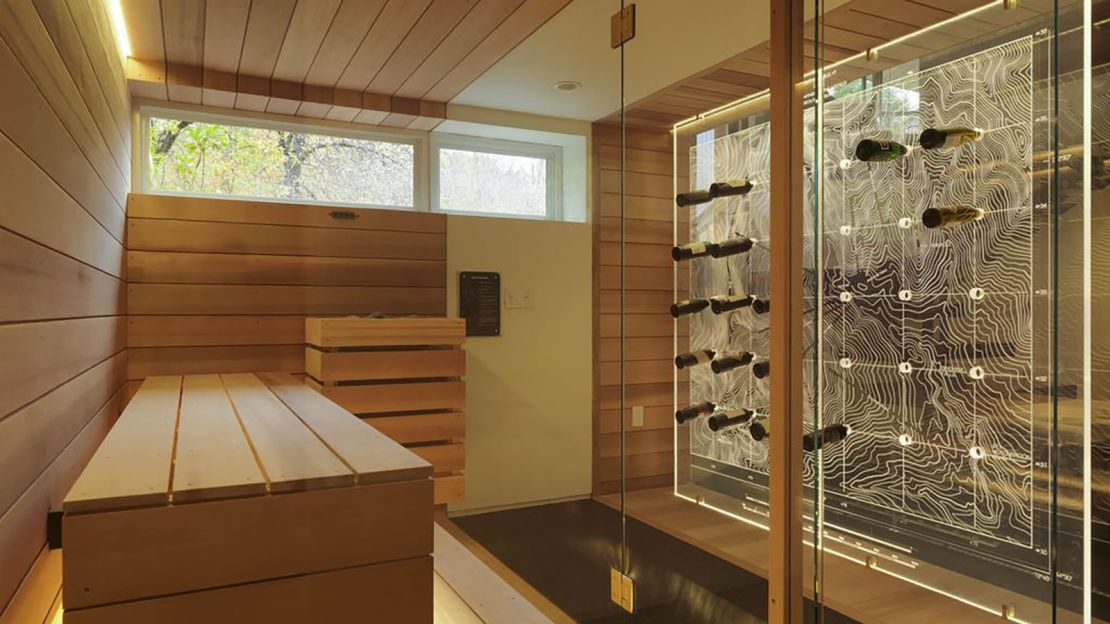 The sauna opens to a wall etched with ski trails that doubles as a wine rack.