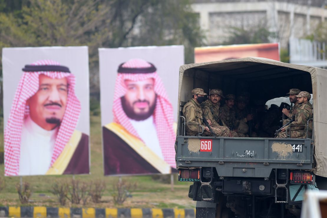 Pakistani soldiers patrol on a street next to welcoming posters of Saudi Arabian Crown Prince Mohammed bin Salman in Islamabad on February 17, 2019.