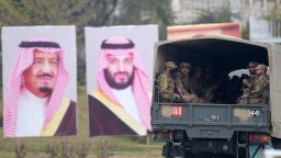 Pakistani soldiers (R) patrol on a street next to welcoming posters of Saudi Arabian Crown Prince Mohammed bin Salman in Islamabad on February 17, 2019. - Saudi Arabia's powerful crown prince arrives in Pakistan on February 17, the start of an Asian tour during which he will seek lucrative contracts and demonstrate he still has allies five months after the Khashoggi affair. Mohammed bin Salman, widely known as "MBS", is expected to land in the capital Islamabad and stay in Pakistan until February 18. (Photo by AAMIR QURESHI / AFP)        (Photo credit should read AAMIR QURESHI/AFP/Getty Images)