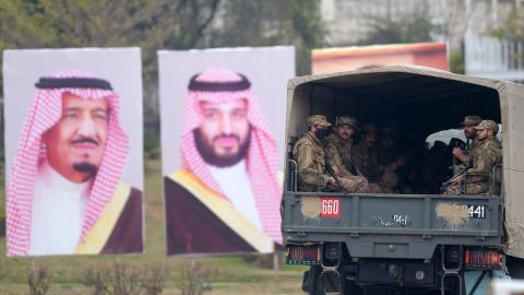 Pakistani soldiers patrol on a street next to welcoming posters of Saudi Arabian Crown Prince Mohammed bin Salman in Islamabad on February 17, 2019.