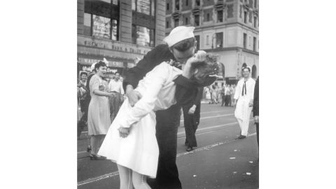 On August 14, 1945, a sailor kisses an unsuspecting woman in New York's Times Square. 